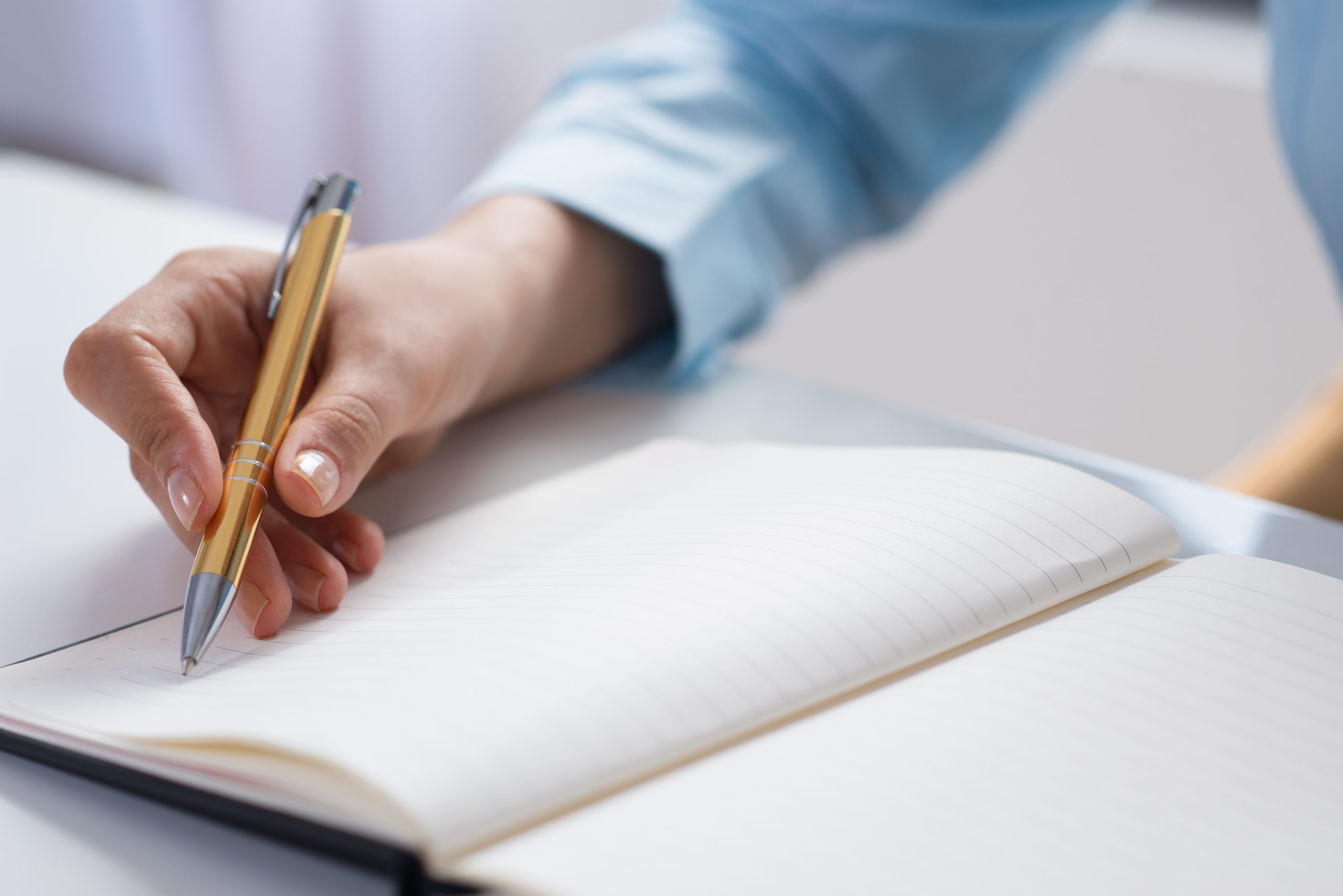 closeup of person making notes in notebook