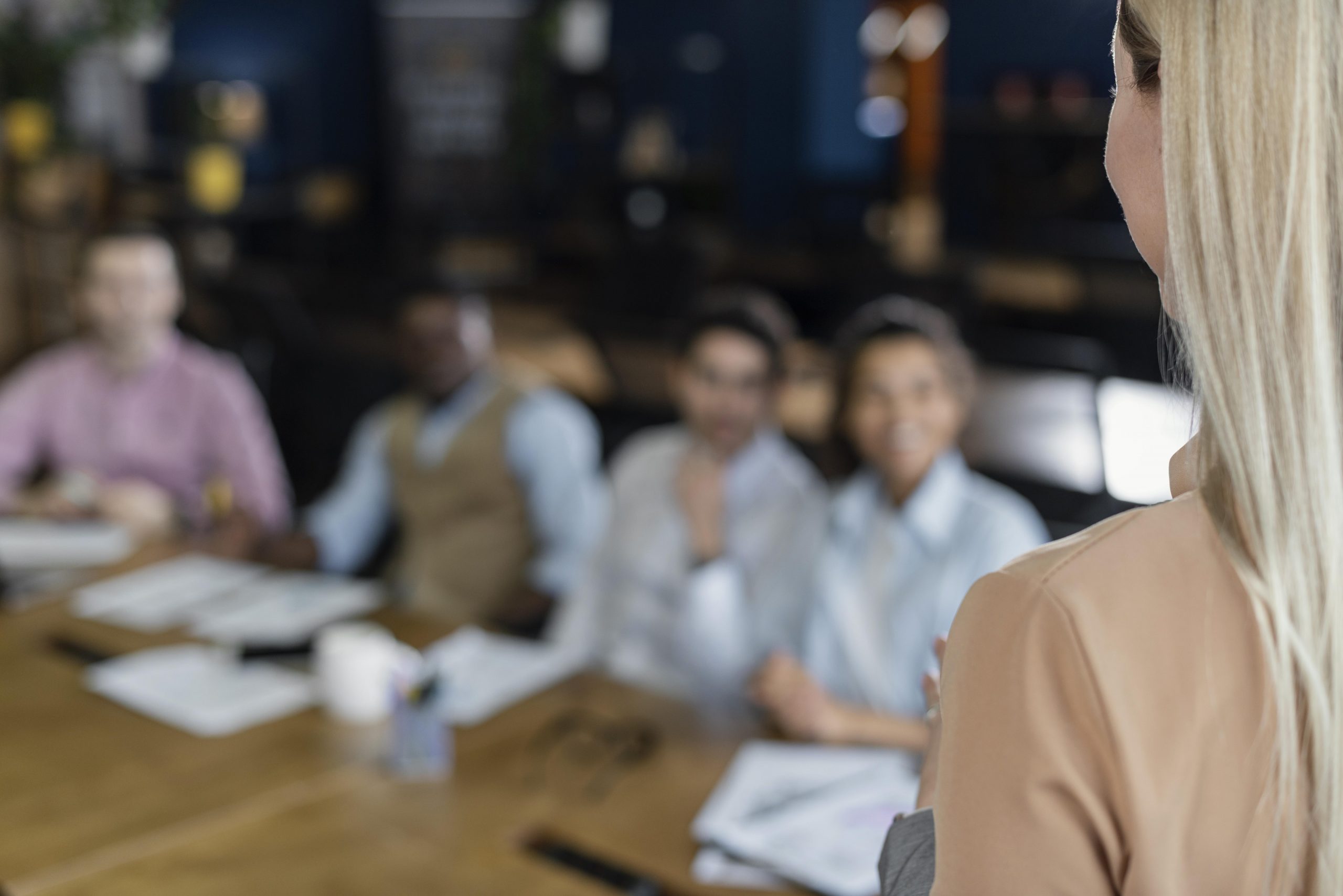 woman holding office meeting with coworkers